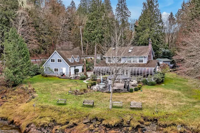 a aerial view of a house with a yard large trees