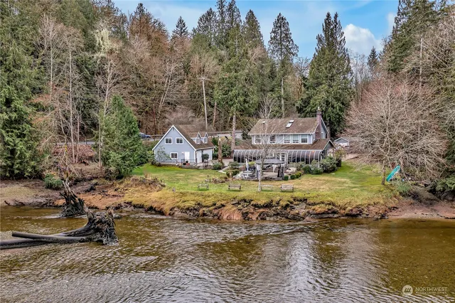 a view of a house with a yard and lake view