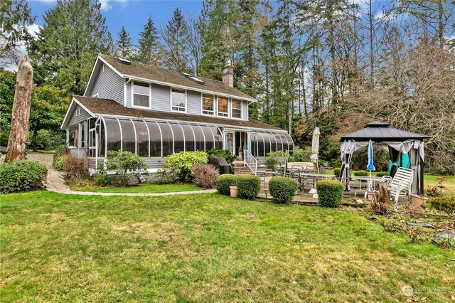 a view of a house with a yard porch and sitting area