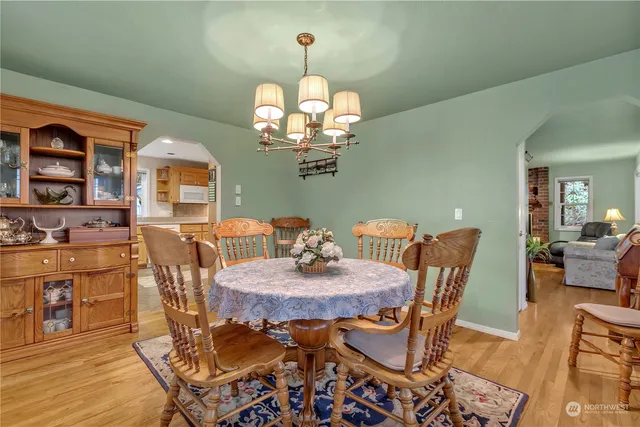 a view of a dining room with furniture and chandelier