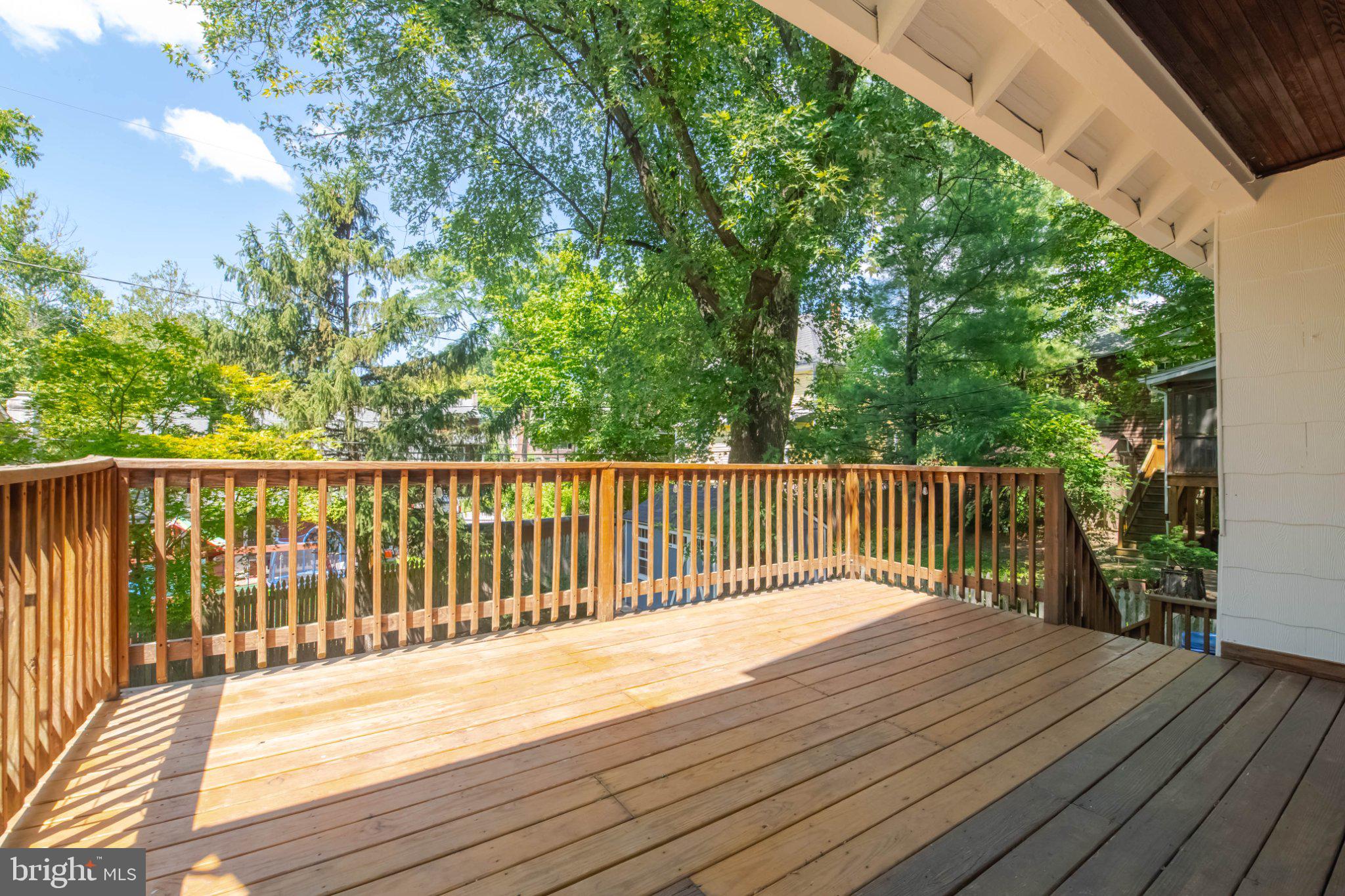 5114 Norwood Road Baltimore, MD 21212 - Photo 46 of 54 Sunny deck surrounded by lush greenery.