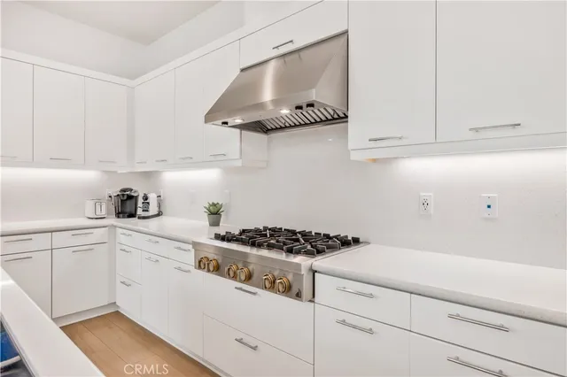 a kitchen with white cabinets and appliances