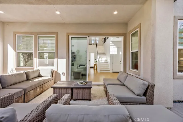a living room with furniture plant and a window