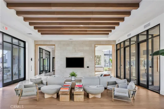 a living room with furniture and floor to ceiling windows
