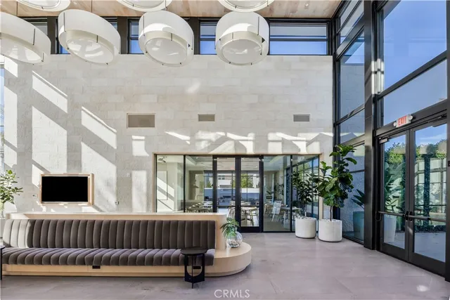 a view of a patio with a table and chairs under an umbrella with a small yard