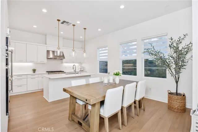 a large kitchen with a table and chairs