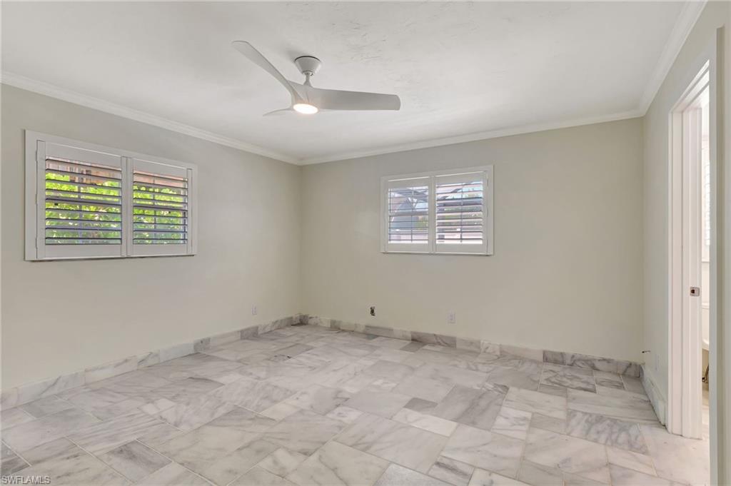 112 Capri Boulevard Naples, FL 34113 - Photo 16 of 39 a view of an empty room with a window