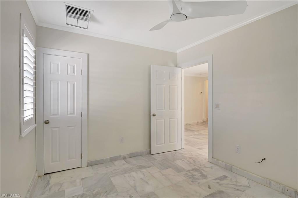 112 Capri Boulevard Naples, FL 34113 - Photo 27 of 39 an empty room with windows and closet