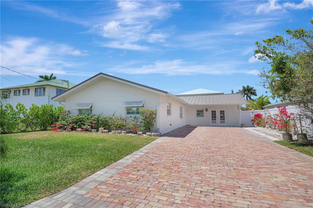 112 Capri Boulevard Naples, FL 34113 - Photo 33 of 39 a front view of house with yard