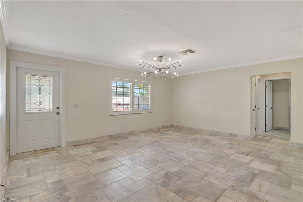 112 Capri Boulevard Naples, FL 34113 - Photo 5 of 39 a view of an empty room with a window