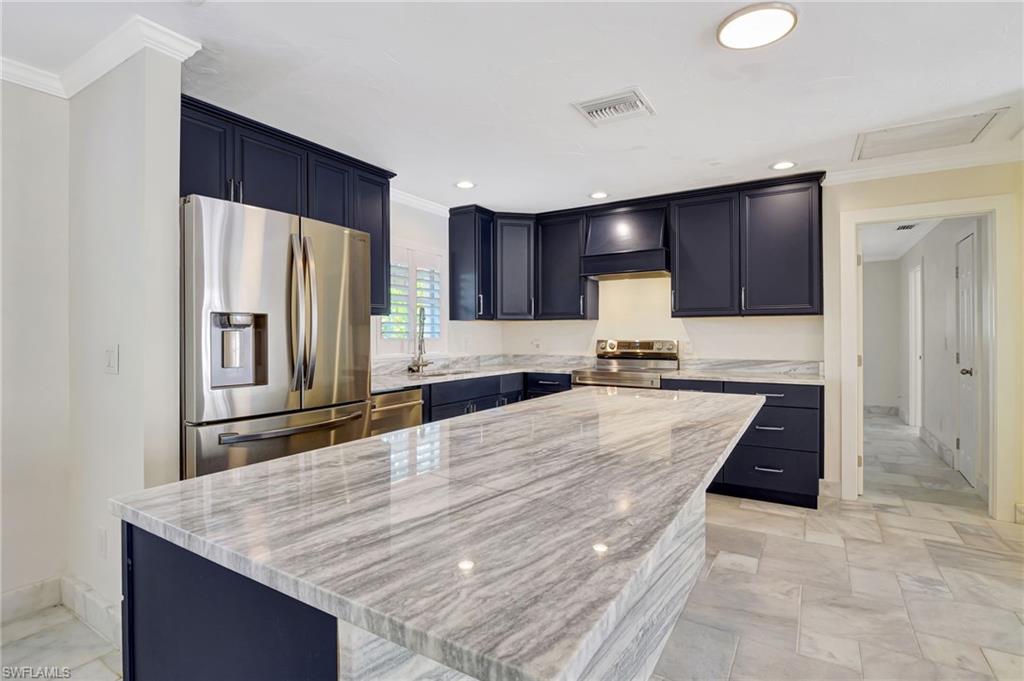 112 Capri Boulevard Naples, FL 34113 - Photo 7 of 39 a kitchen with refrigerator and window
