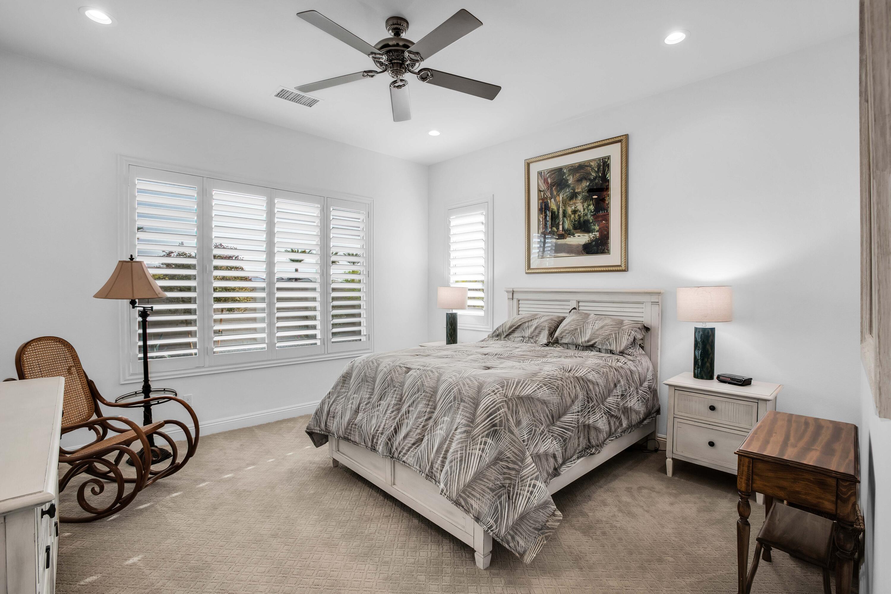 32 Cork Tree Rancho Mirage, CA 92270 - Photo 22 of 58 a bedroom with a bed a table and chair