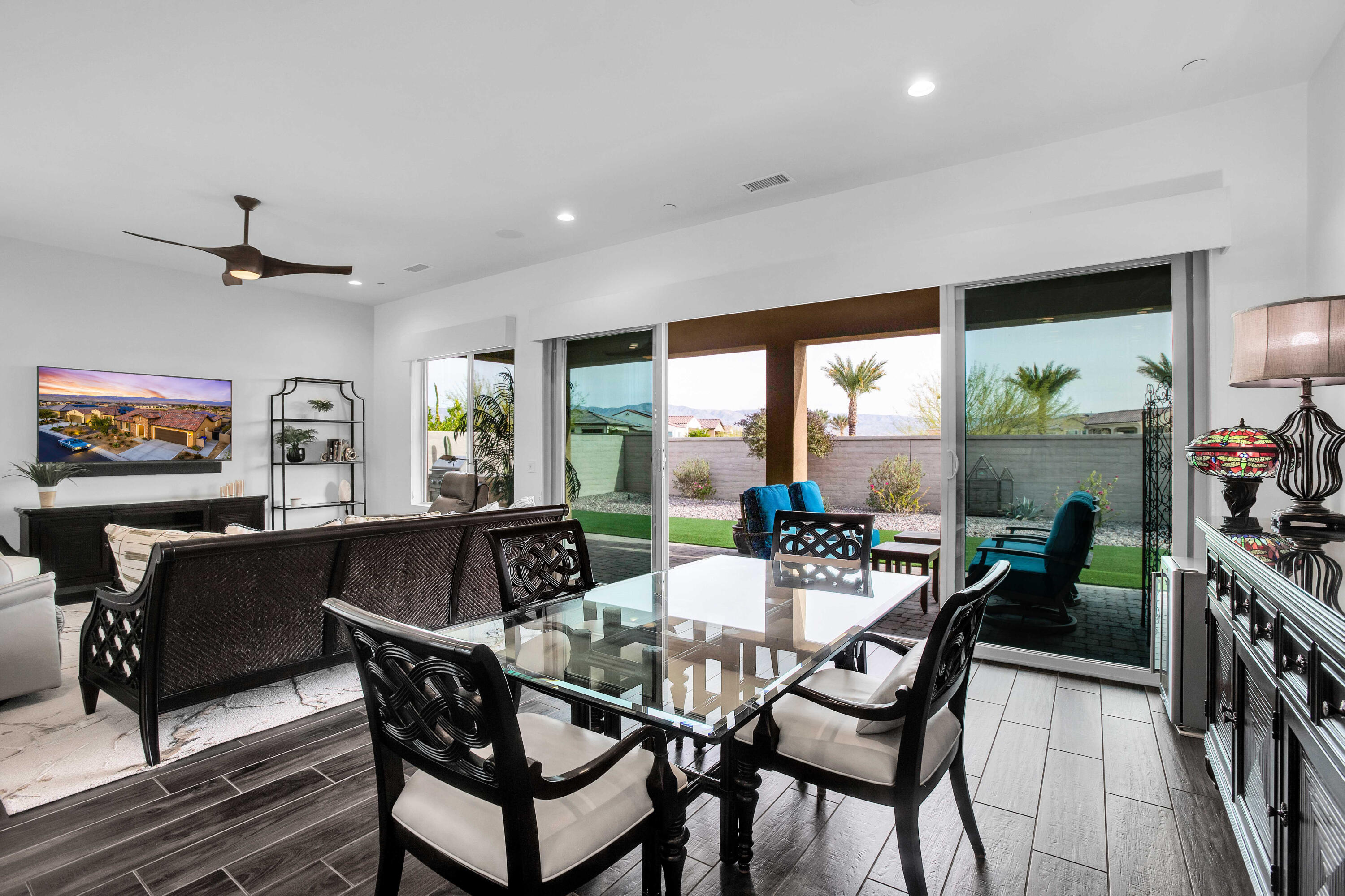32 Cork Tree Rancho Mirage, CA 92270 - Photo 9 of 58 a dining room with furniture a rug and a floor to ceiling window