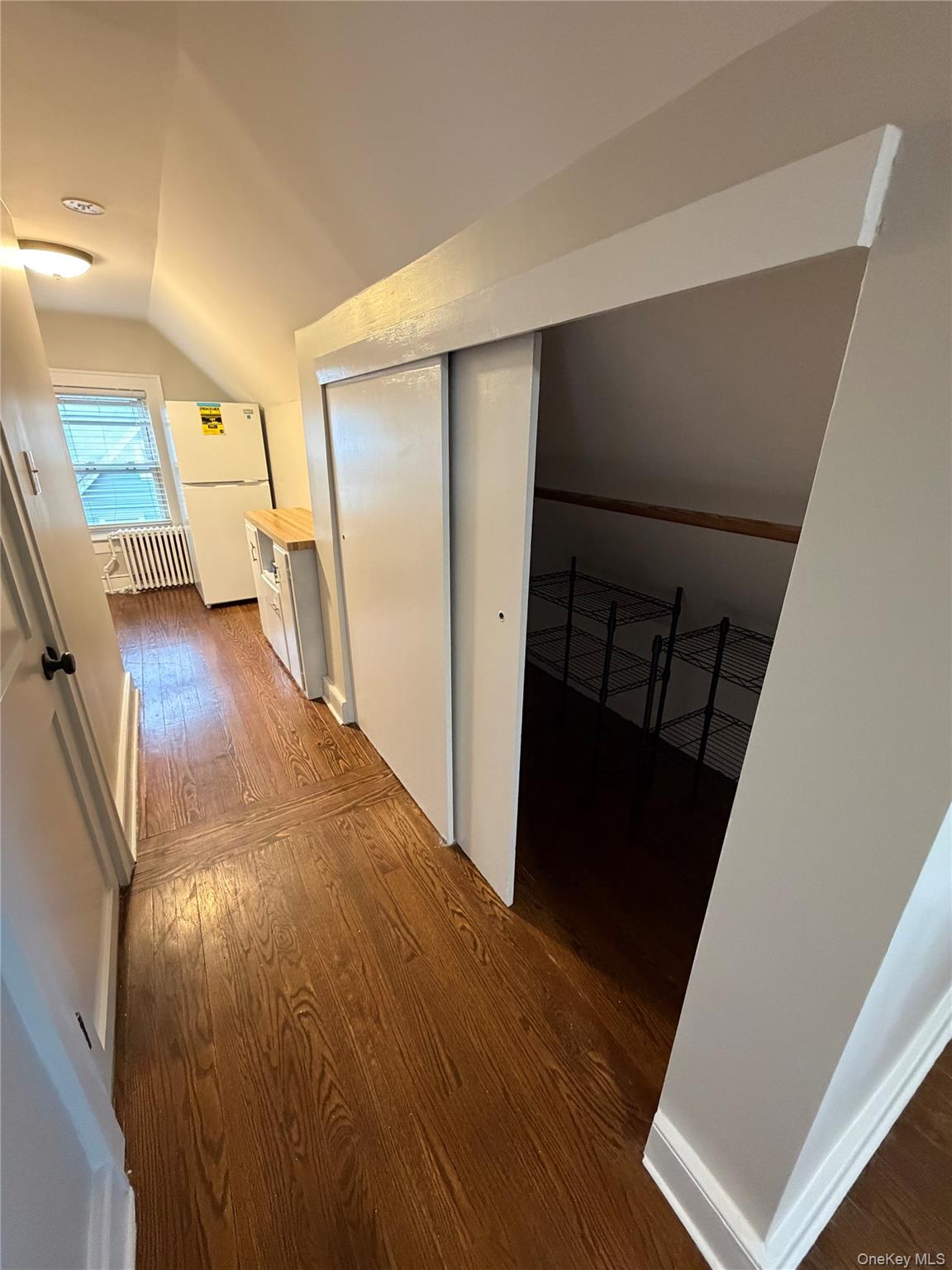 196 Depew Avenue, Unit 3 Nyack, NY 10960 - Photo 4 of 15 Hallway with vaulted ceiling, dark wood-style floors, and radiator