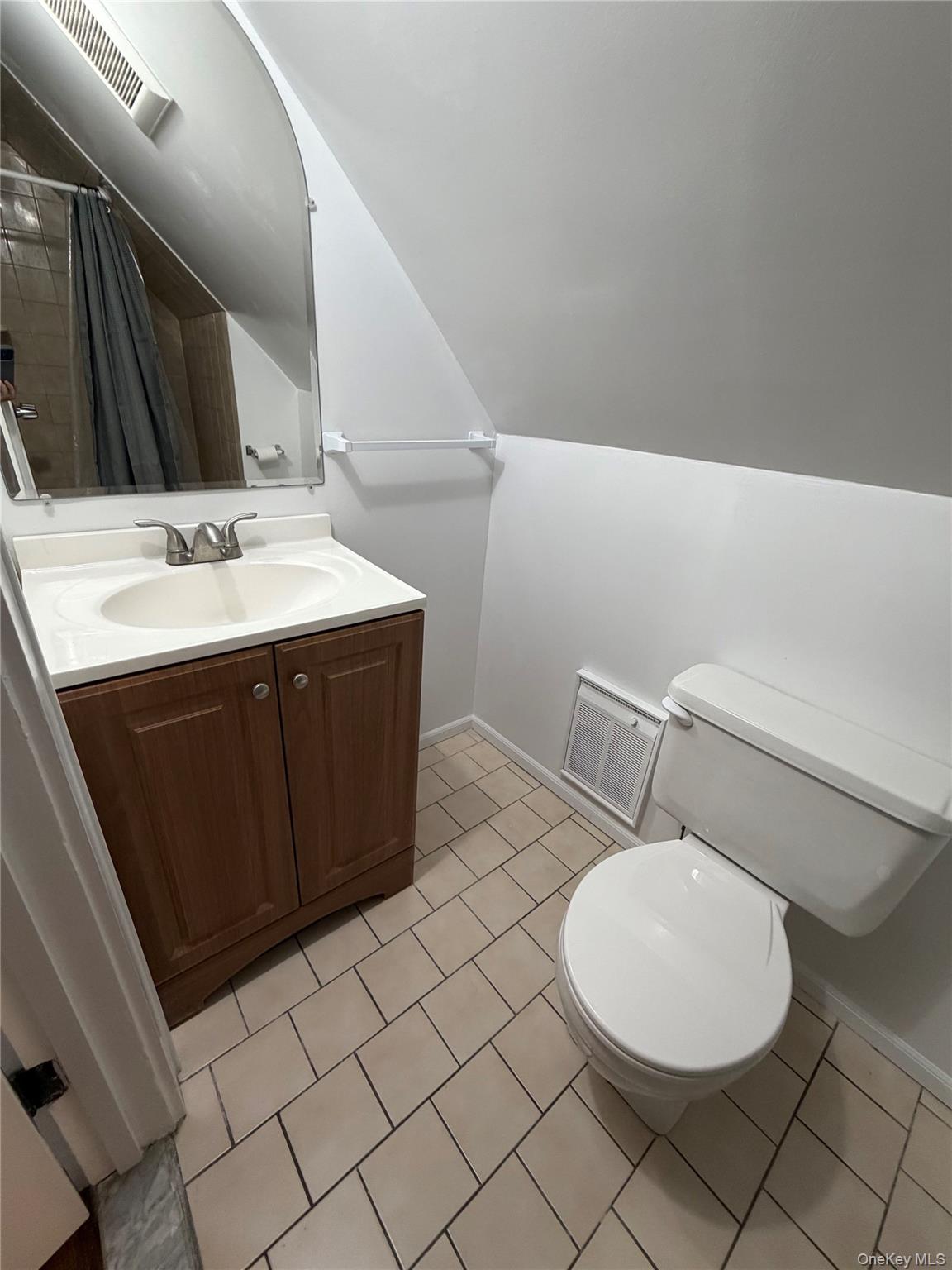196 Depew Avenue, Unit 3 Nyack, NY 10960 - Photo 7 of 15 Full bath with vanity, curtained shower, light tile patterned floors, and vaulted ceiling
