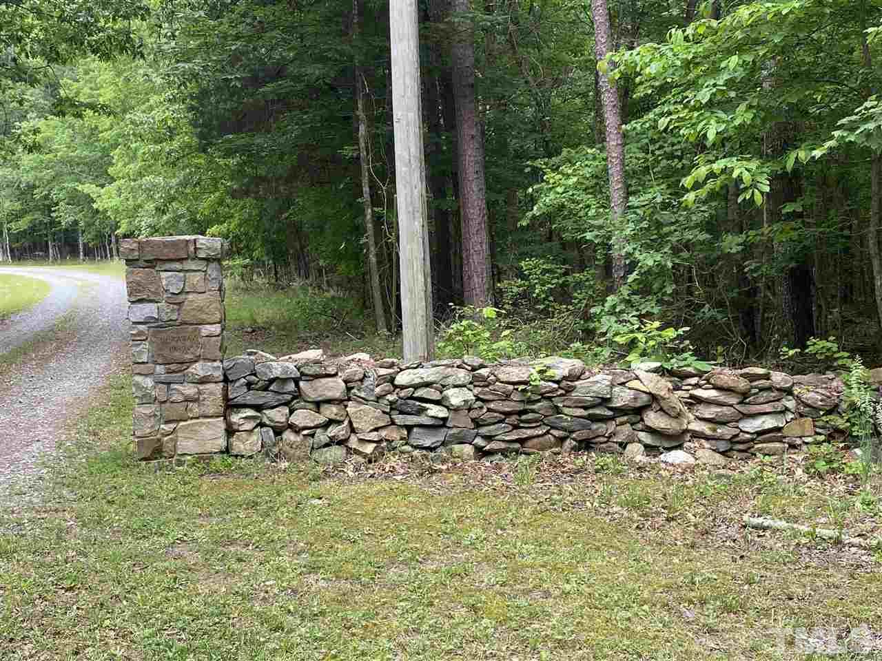 1816 Harris Road Rougemont, NC 27572 - Photo 9 of 12 a view of a lake with a bench