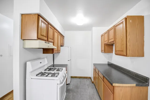 a kitchen with a stove and a refrigerator