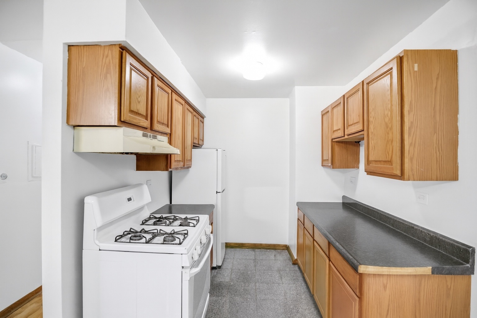 1080 Knoll Lane, Unit 305 Hoffman Estates, IL 60169 - Photo 6 of 10 a kitchen with a stove and a refrigerator