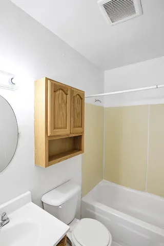 a bathroom with a toilet a sink and bathtub