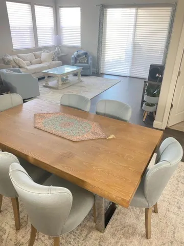 a room with a table chairs and a sink