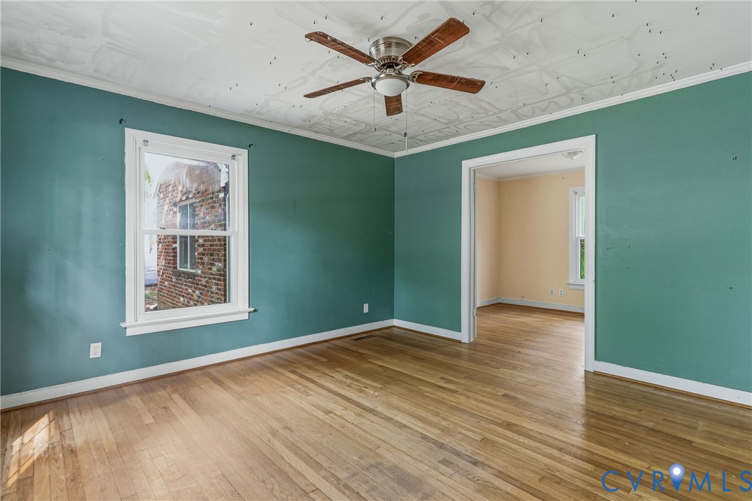 11840 Winfore Drive Midlothian, VA 23113 - Photo 17 of 59 a view of an empty room with window and wooden floor