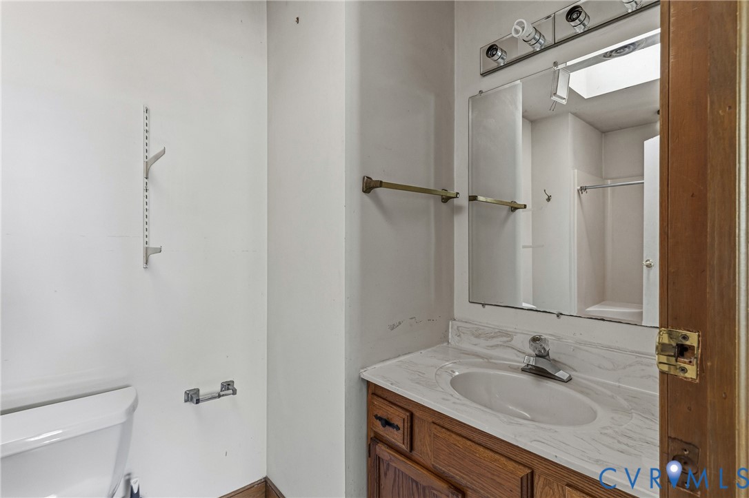 11840 Winfore Drive Midlothian, VA 23113 - Photo 34 of 59 a bathroom with a granite countertop sink toilet and mirror