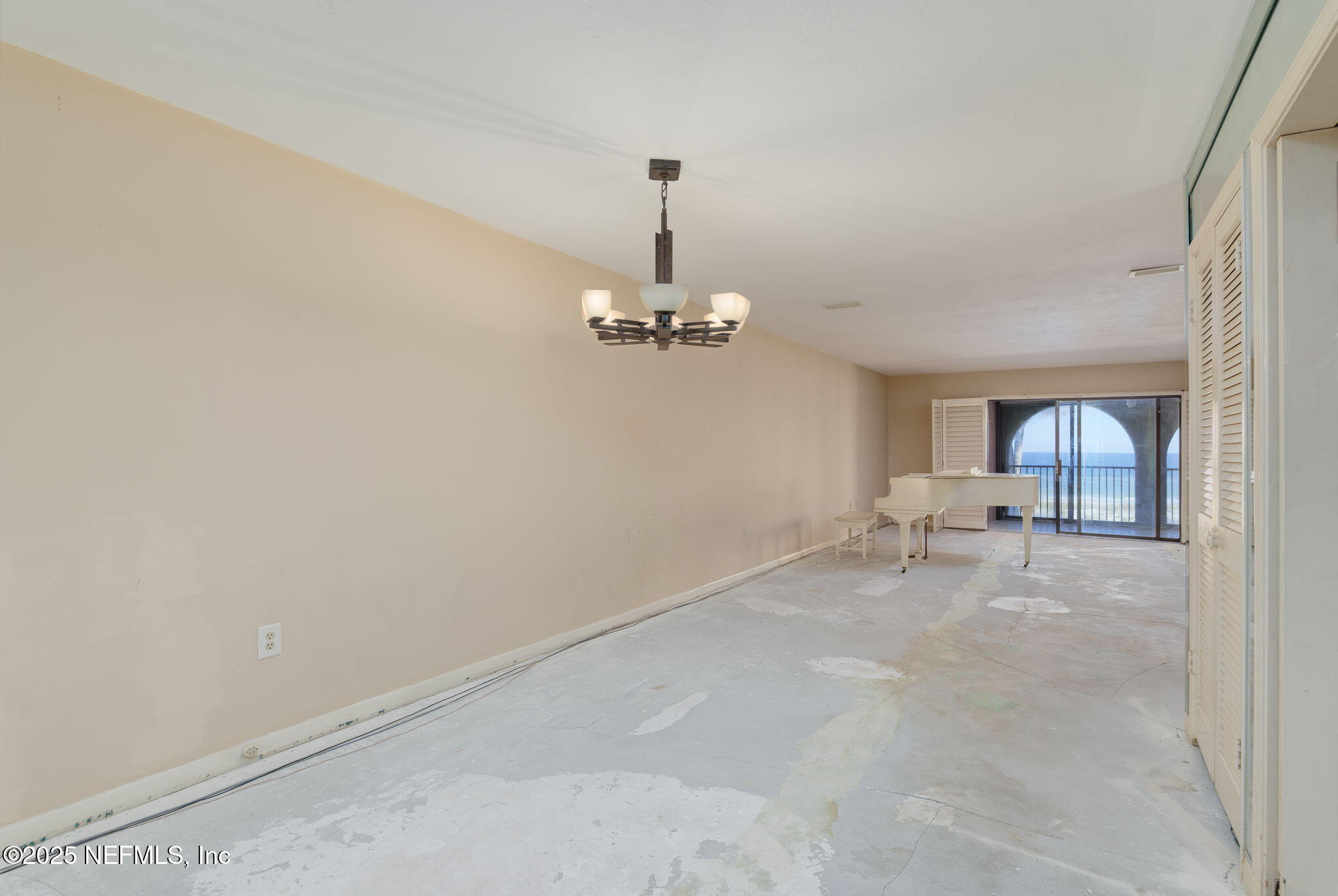 10 10th Street, Unit 2 Atlantic Beach, FL 32233 - Photo 12 of 43 a view of a livingroom with a chair and chandelier