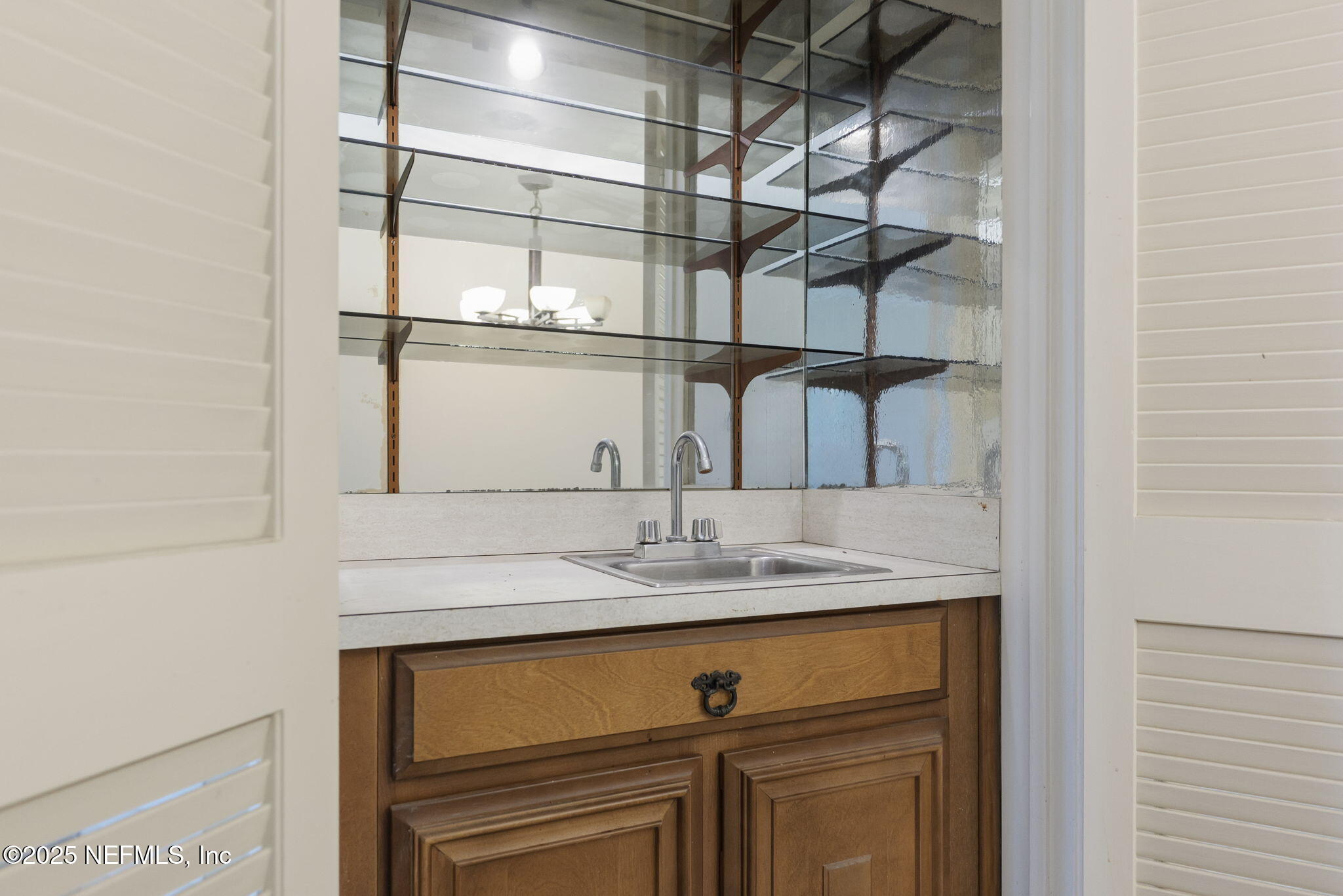 10 10th Street, Unit 2 Atlantic Beach, FL 32233 - Photo 14 of 43 a bathroom with a sink and a mirror