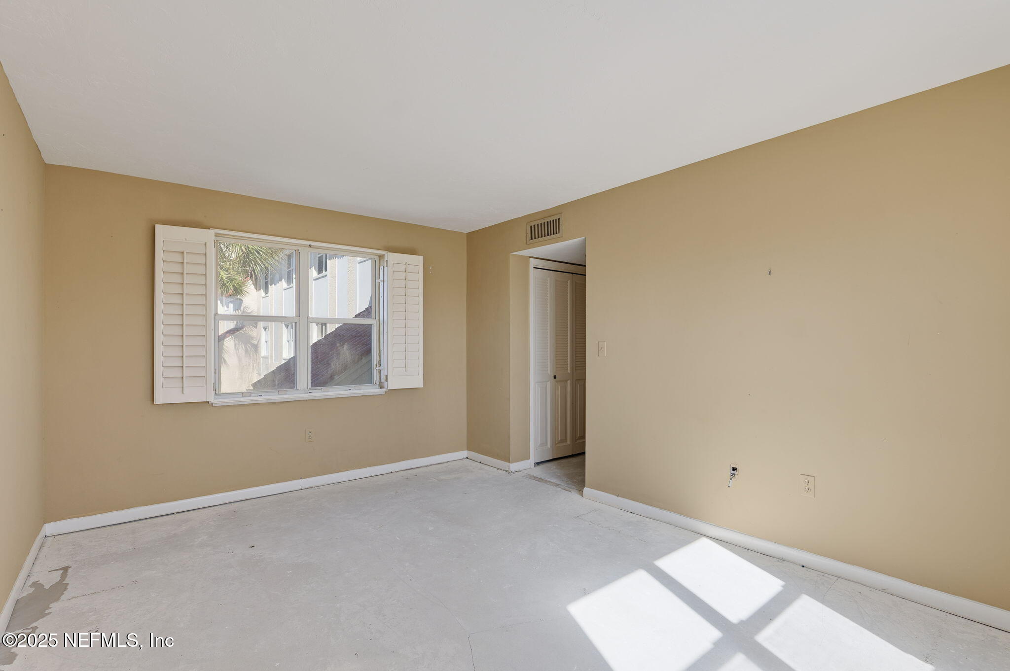 10 10th Street, Unit 2 Atlantic Beach, FL 32233 - Photo 36 of 43 a view of an empty room with window and wooden floor