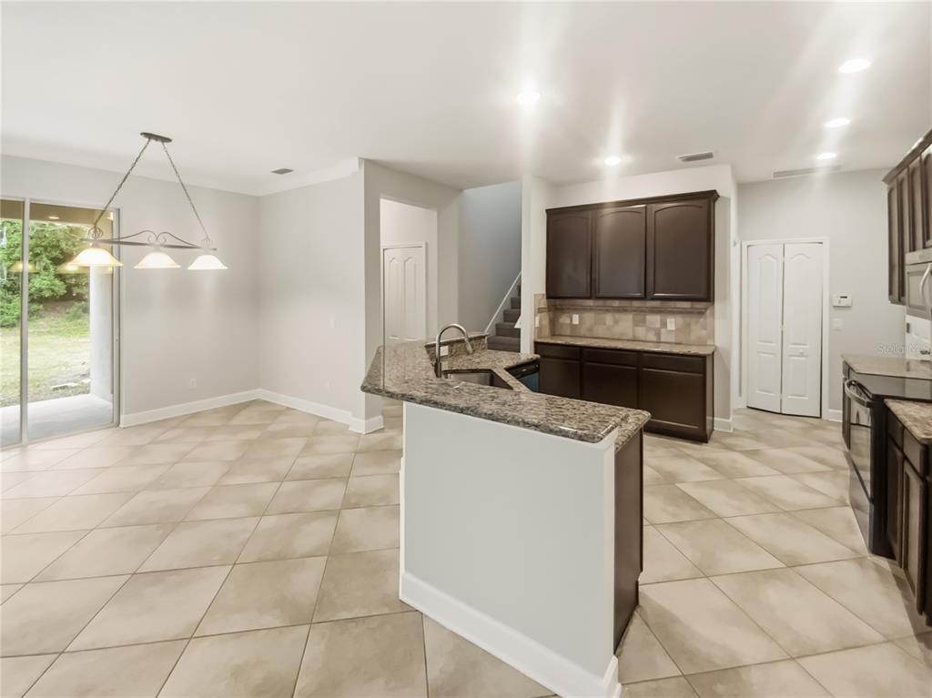 4307 Rustic Pine Place Wesley Chapel, FL 33544 - Photo 11 of 38 a kitchen with kitchen island a sink stainless steel appliances and cabinets
