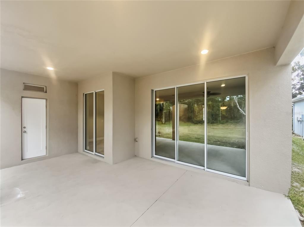 4307 Rustic Pine Place Wesley Chapel, FL 33544 - Photo 17 of 38 an empty room with sliding glass door and shower
