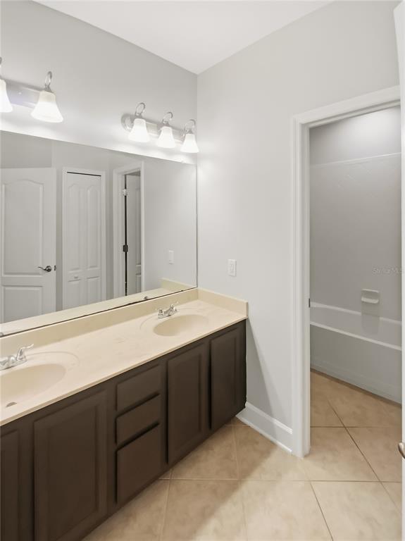 4307 Rustic Pine Place Wesley Chapel, FL 33544 - Photo 31 of 38 a bathroom with a double vanity sink mirror and bathtub