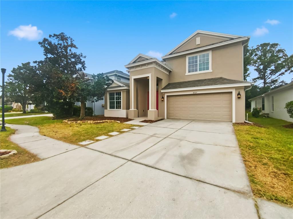4307 Rustic Pine Place Wesley Chapel, FL 33544 - Photo 38 of 38 a front view of a house with a yard and potted plants