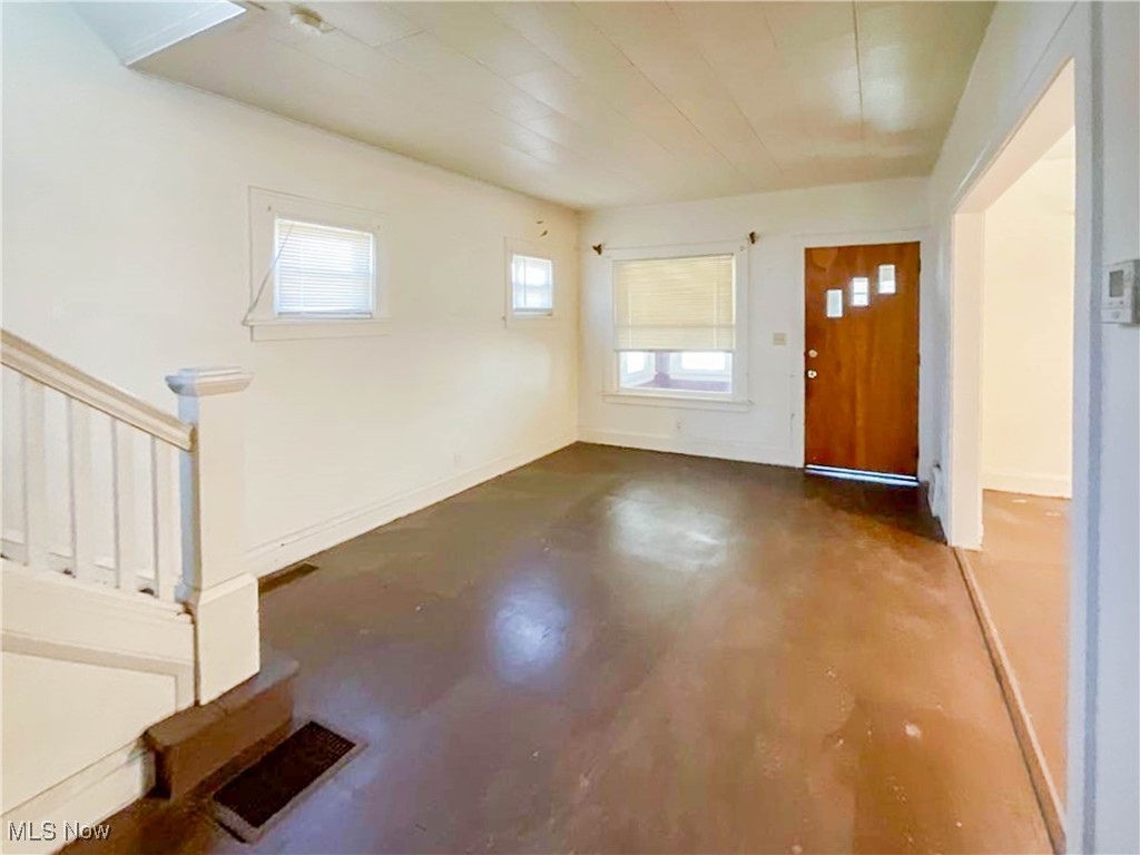 14703 Granger Road Maple Heights, OH 44137 - Photo 6 of 35 Foyer with concrete floors, visible vents, and baseboards