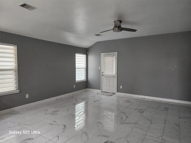 a view of an empty room with a window