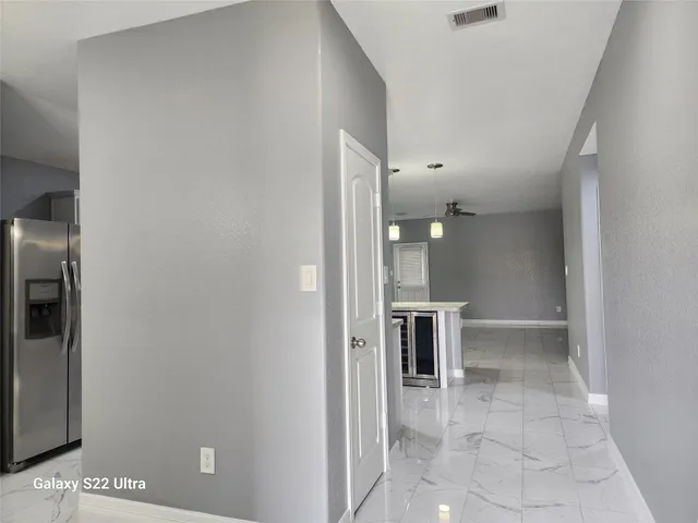 a view of kitchen with furniture and refrigerator