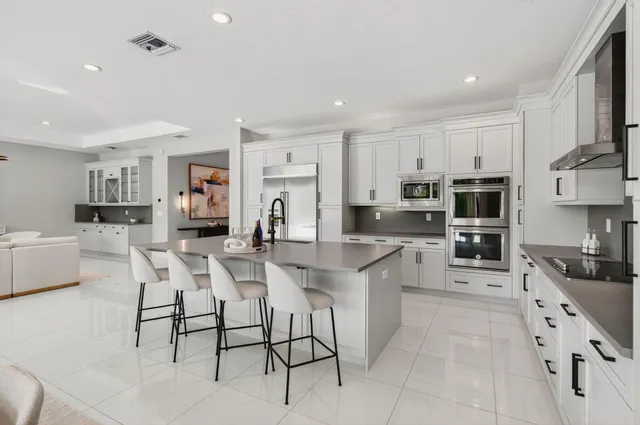 a bedroom with a bed chandelier and a window