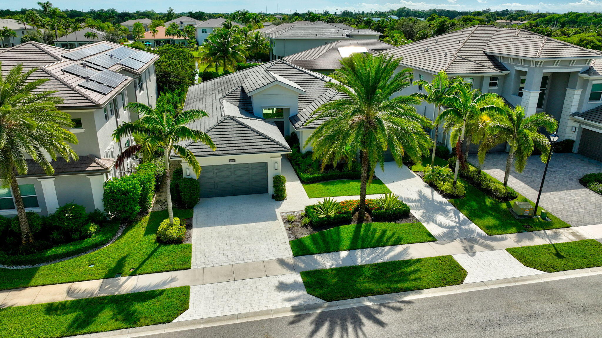 19886 Meadowside Lane Boca Raton, FL 33498 - Photo 63 of 84 a front view of a house with a yard and potted plants