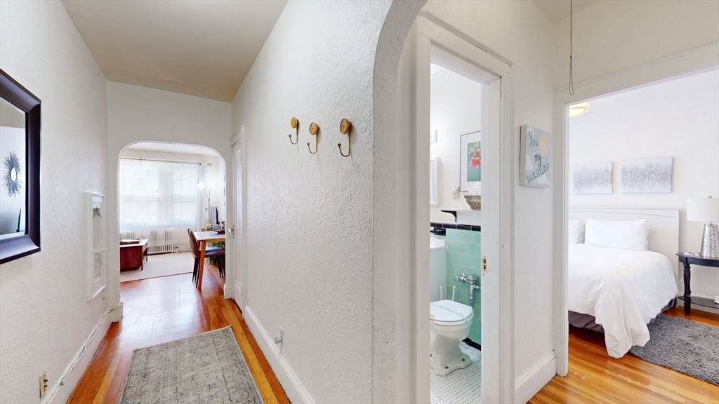 90 Kilsyth Road, Unit 43FURNISHED Boston, MA 02135 - Photo 10 of 11 a view of a bedroom with a bed and wooden floor