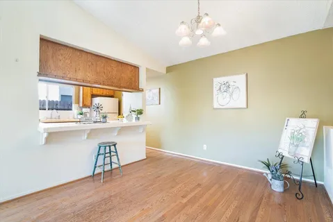 a kitchen with a sink cabinets and wooden floor