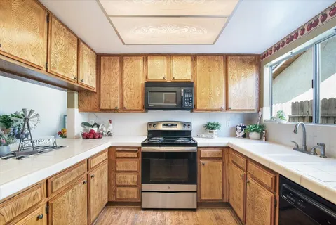 a kitchen with a sink stove and microwave