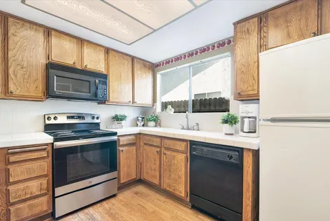 a kitchen with a sink stove and microwave