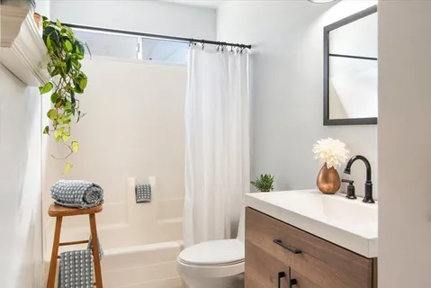 a bathroom with a sink toilet and shower
