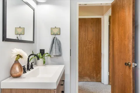 a bathroom with a sink a mirror and vanity