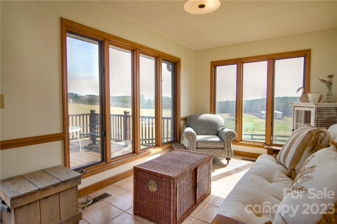 7100 Highway 108 Mill Spring, NC 28756 - Photo 21 of 48 a living room with furniture and a floor to ceiling window
