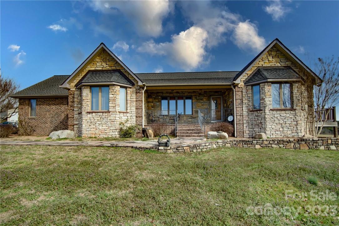 7100 Highway 108 Mill Spring, NC 28756 - Photo 22 of 48 a front view of a house with a yard