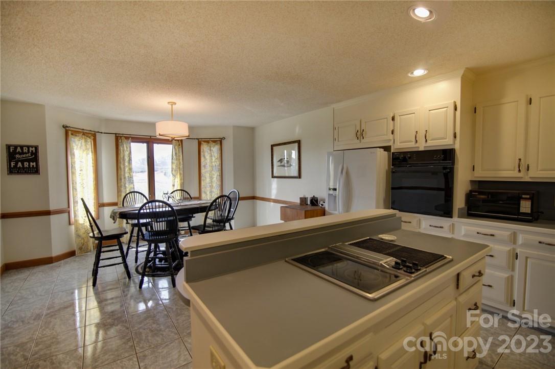 7100 Highway 108 Mill Spring, NC 28756 - Photo 25 of 48 a living room with stainless steel appliances furniture a dining table and kitchen view