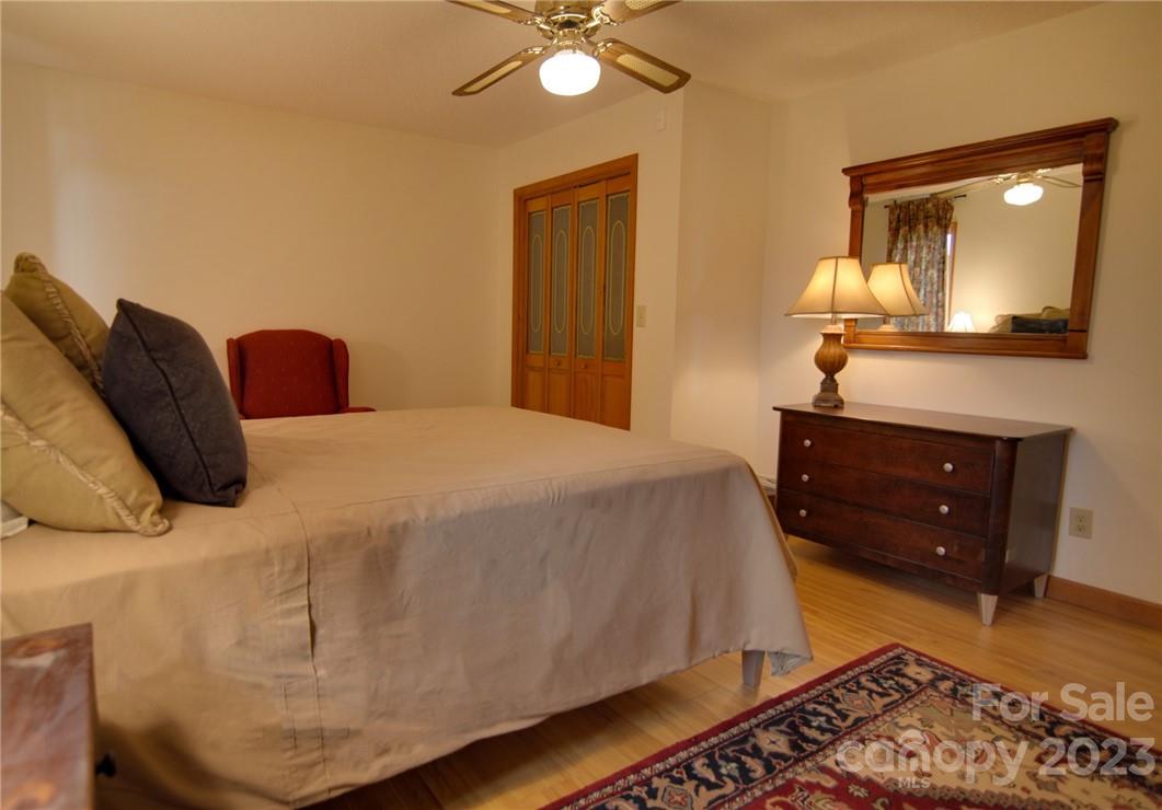 7100 Highway 108 Mill Spring, NC 28756 - Photo 31 of 48 a bedroom with a bed and a dresser