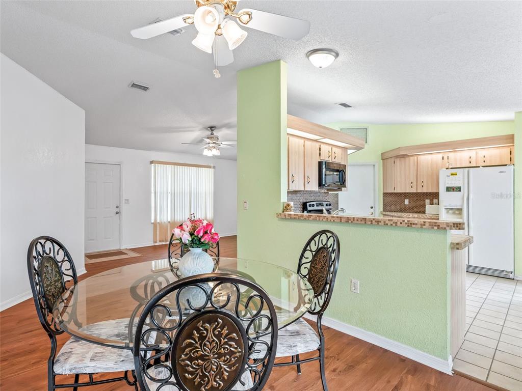 8850 Southwest 116th Place Road Ocala, FL 34481 - Photo 11 of 53 a view of a dining room with furniture and wooden floor