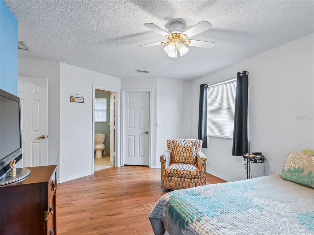 8850 Southwest 116th Place Road Ocala, FL 34481 - Photo 19 of 53 a bedroom with a bed and a chandelier